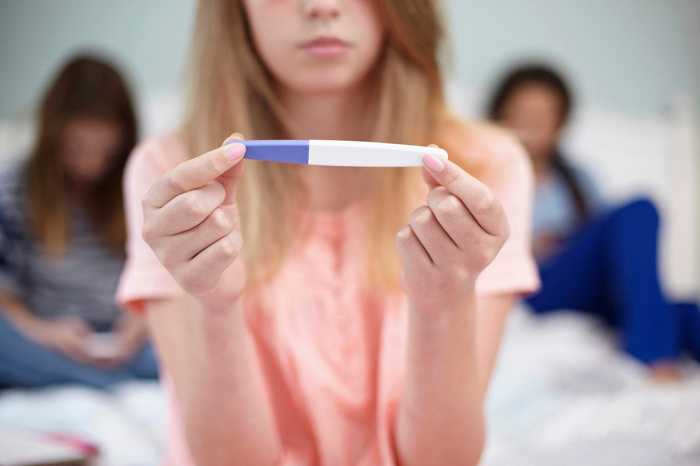 Girl holding a pregnancy test